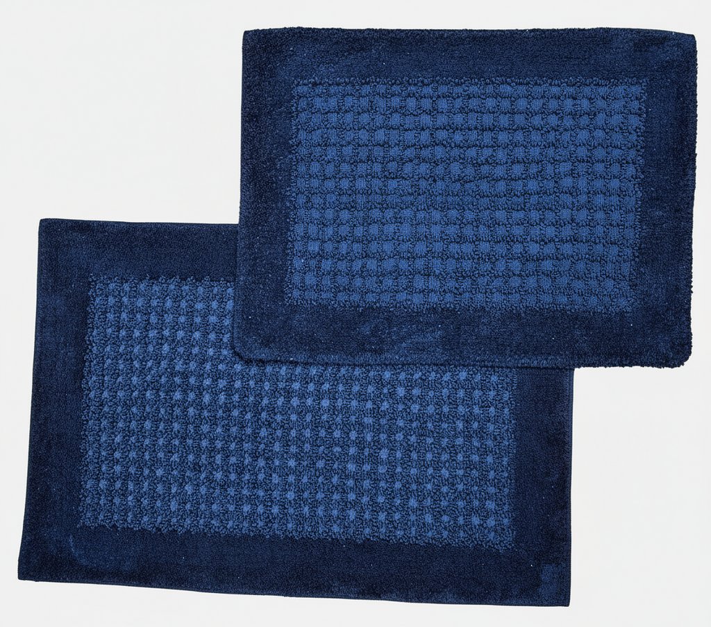 Two blue textured bath mats on a light gray background