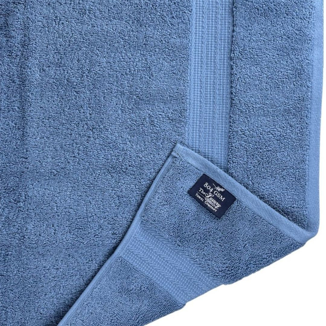 Blue towel with a brand label on a white background