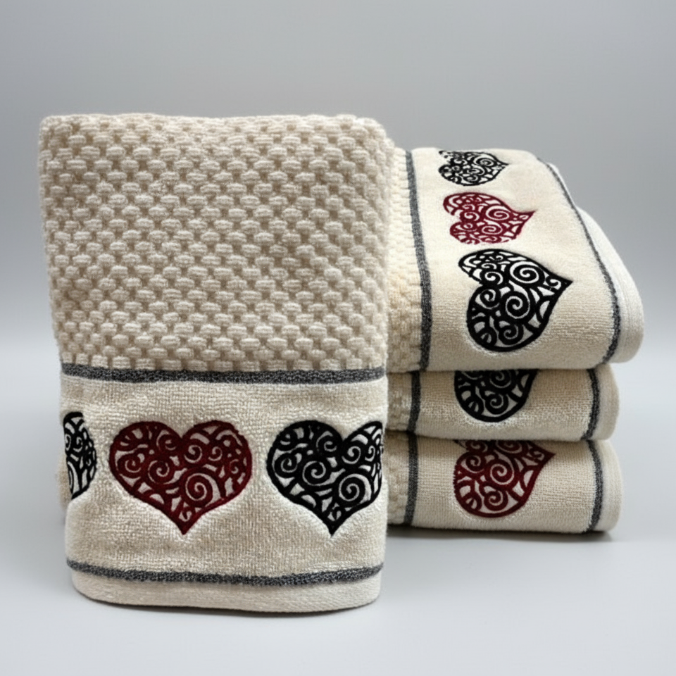 Set of towels with heart patterns on a gray background